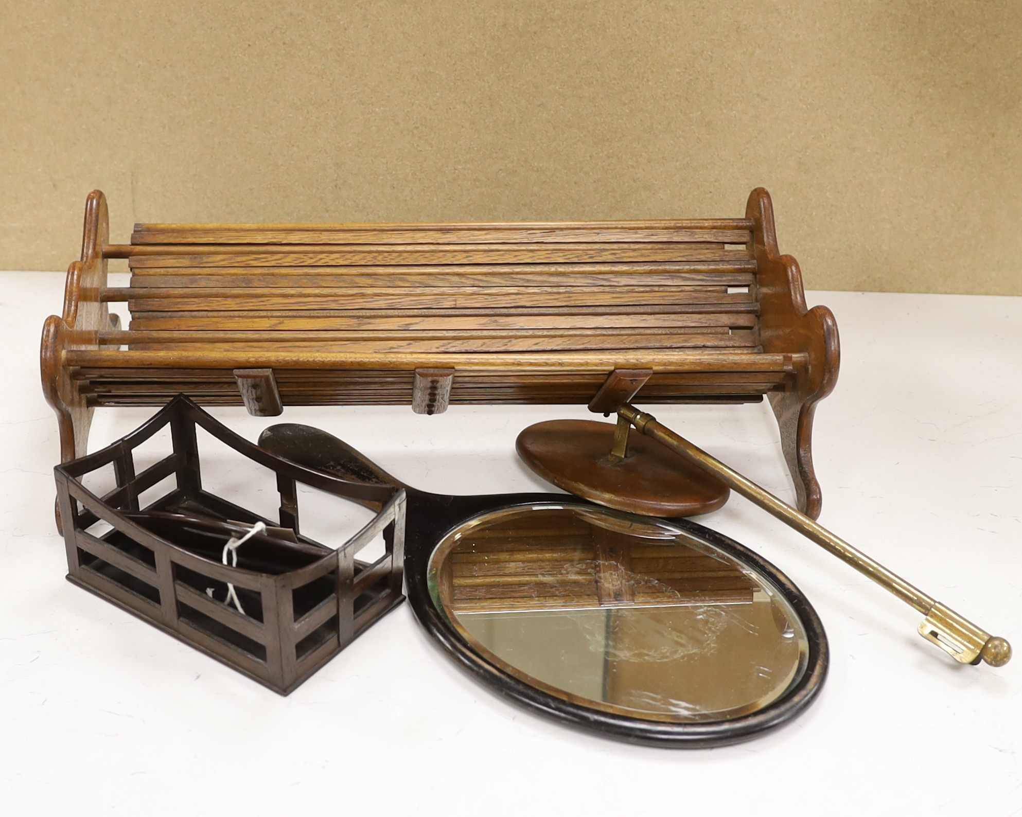 An oak book trough, a rosewood rack, a hand mirror and a telescopic hand mirror